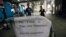 A sign requesting people to come have their temperature taken is seen at the entrance to the Canton Fair in Guangzhou, Guangdong province, Oct. 26, 2014.