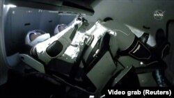 Spacex crew while attaching to the NASA space station 