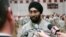 FILE - U.S. Army Capt. Tejdeep Singh Rattan speaks to journalists at Fort Sam Houston in San Antonio, March 22, 2010. Rattan was the first Sikh allowed to complete officer basic training while wearing the traditional turban and full beard since the Army altered its dress code. The New York City police have now adopted a similar dress policy.