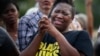 Cara McClure, of Birmingham, Alabama, cries during a solidarity gathering Aug. 13, 2017, in Birmingham for the victims in Charlottesville, Virginia.