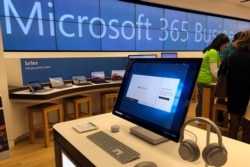 In this Tuesday, Jan. 28, 2020, photo a Microsoft computer is among items displayed at a Microsoft store in suburban Boston. Microsoft reports financial results on Jan. 29, 2020.