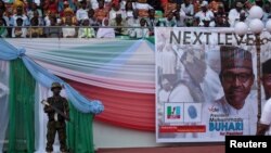 FILE - A soldier stands guard during a launch campaign by the ruling All Progressives Congress (APC) party for President Muhammadu Buhari's re-election bid, in Uyo, Nigeria, Dec. 28, 2018.