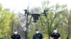 Police officers prepare a drone to find residents who fail to comply with the stay-at-home order implemented due to the coronavirus pandemic in Szolnok, Hungary, April 13, 2020.
