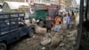 Members of the bomb disposal unit survey the site after a blast at a vegetable market in Quetta, Pakistan, April 12, 2019.