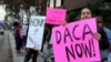 FILE - Demonstrators urging the Democratic Party to protect the Deferred Action for Childhood Arrivals Act (DACA) rally outside the office of California Democratic Sen. Dianne Feinstein in Los Angeles, Jan. 3, 2018. 