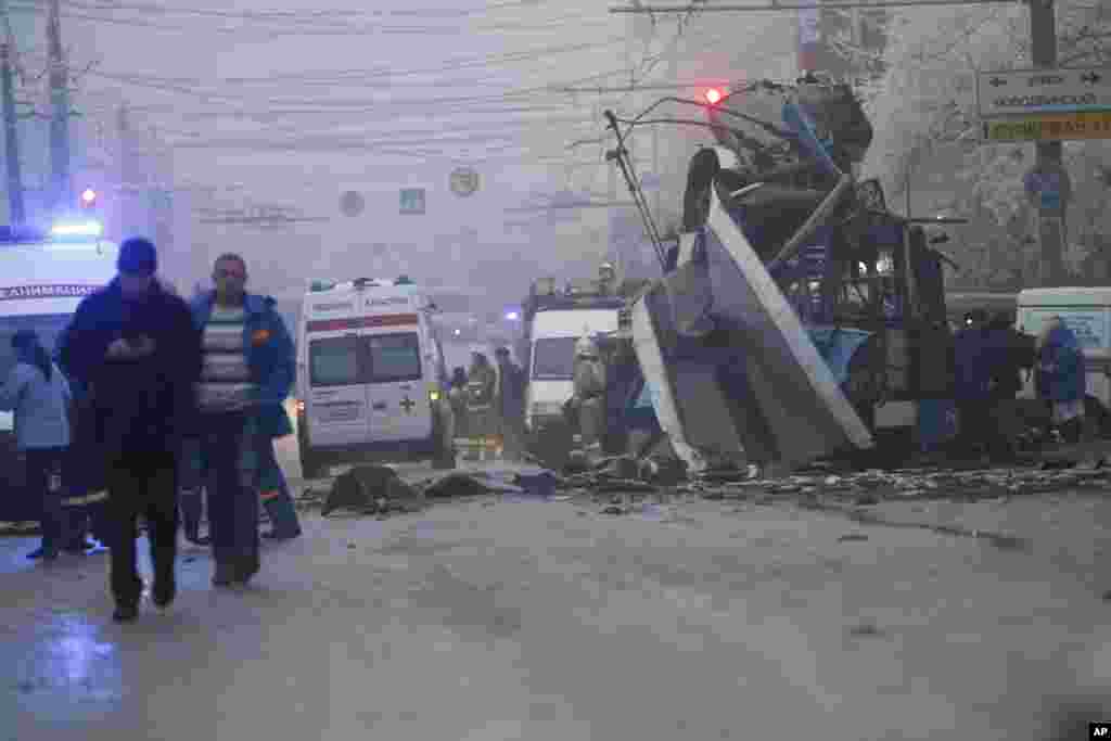 Ambulances line up at the site of a trolleybus explosion, background, in Volgograd, Russia. A bomb blast tore through the trolleybus, killing at least 10 people a day after a suicide bombing that killed at 17 at the city&rsquo;s main railway station.