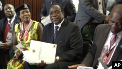 FILE: Emmerson Mnangagwa, center, and Saviour Kasukuwere (far left) seen at ZANU-PF headquarters in Harare, Zimbabwe, Dec, 10, 2014. 