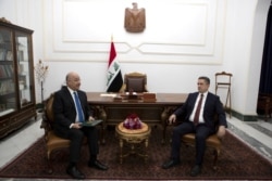 FILE - Iraq's President Barham Salih meets with Prime Minister-designate Adnan al-Zurfi in Baghdad, Iraq, March 17, 2020.
