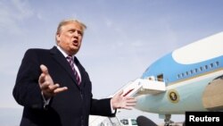 U.S. President Donald Trump talks to reporters prior to boarding Air Force One as he departs Washington to campaign in California from Joint Base Andrews in Maryland, Feb. 18, 2020.