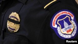 A U.S. Capitol Police officer wears a black band over his badge in honor of officer Brian Sicknick, who died Thursday night after he was injured during the attack on the Capitol the day before, January 8, 2021.