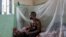 FILE - A man suffering from mpox waits for treatment at the Kamituga General Hospital in South Kivu, Congo, on Sept. 4, 2024.