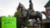 Protesters gather below a monument dedicated to Confederate Major John B. Castleman while demanding that it be removed from the public square in Louisville, Ky., Aug. 14, 2017. 