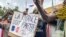 TOPSHOT - Protesters hold an anti-France placard during a demonstration on independence day in Niamey on August 3, 2023.