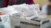 Democratic and Republican representatives review absentee ballots at the Fulton County Election preparation Center, Nov. 4, 2020 in Atlanta. 