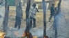 Men look at a market destroyed by a Sudanese air strike in Rubkona, near Bentiu, South Sudan, April 23, 2012.