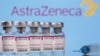 Vials labelled "Astra Zeneca COVID-19 Coronavirus Vaccine" and a syringe are seen in front of a displayed AstraZeneca logo, in this illustration photo taken March 14, 2021.