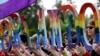Members of Capital City Pride and others from the LGBT community hold up letters spelling out "Orlando" to honor of the recent shooting at a gay nightclub days earlier before the raising of a rainbow flag in front of the Washington state Capitol, June 15, 2016.