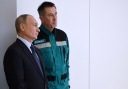 FILE - Russian President Vladimir Putin, left, speaks with Chairman of the Management Board of the Sibur company Dmitry Konov as they visit a plant in Tobolsk, Russia, Dec. 1, 2020. (Sputnik/Alexei Nikolsky/Kremlin via Reuters)