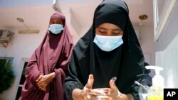 Somali female wash their hands during coronavirus awareness training conducted by the local paramedics and doctors in Somali capital Mogadishu, Thursday, March, 19, 2020.