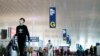 Travellers are seen at the Wuhan Tianhe International Airport after travel restrictions to leave Wuhan, the capital of Hubei province and China's epicentre of the novel coronavirus disease (COVID-19) outbreak, were lifted, April 8, 2020. REUTERS/Aly…