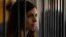 Member of the female punk band "Pussy Riot" Nadezhda Tolokonnikova looks out from a holding cell as she attends a court hearing to appeal for parole at the Supreme Court of Mordovia in Saransk, July 26, 2013. REUTERS/Sergei Karpukhin (RUSSIA - Tags: POLIT