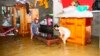 Residents move their belongings in a flooded house to higher ground in Vietnam's central province of Quang Binh October 18, 2011.