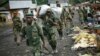 FILE - In this Nov. 30, 2012 file photo, M23 rebels withdraw from the Masisi and Sake areas in the eastern Congo town of Sake, some 27 kms west of Goma, Congo. 