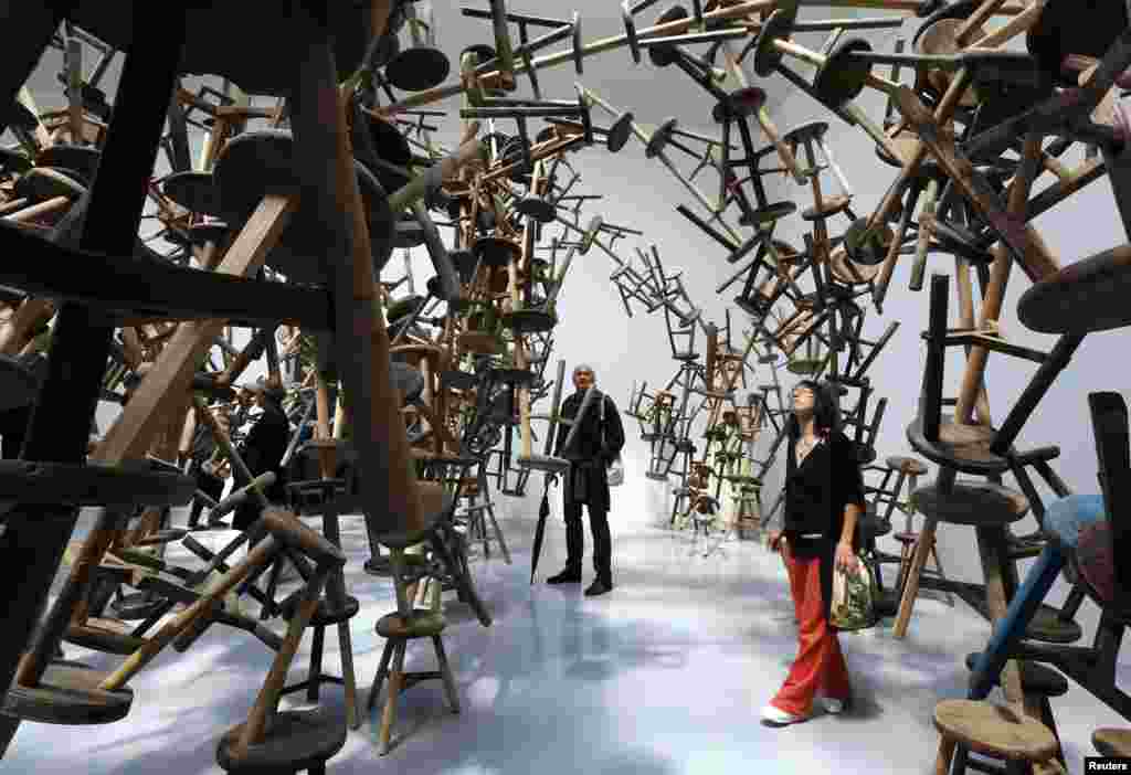 Visitors looks at the installation called " Bang " by China's artist Ai Weiwei at the German pavilion during the 55th La Biennale of Venice, May 29, 2013.
