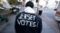 A voter wears a message on his jacket on Election Day, Nov. 6, 2012, in Hoboken, N.J. 
