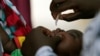 FILE - A child is given a dose of polio vaccine at an immunisation health center, in Maiduguri, Borno state, Nigeria, Aug. 29, 2016. 