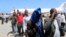 FILE- Deported Somali nationals gesture as they arrive at the airport in Somalia's capital of Mogadishu, April 9, 2014. Sixty-eight Somalis arrived in Mogadishu Friday, having been deported by U.S. immigration authorities.