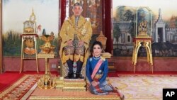 This undated photo posted Monday, Aug. 26, 2019 on the Thailand Royal Office website shows King Maha Vajiralongkorn with Major General Sineenatra Wongvajirabhakdi, the royal noble consort. She was bestowed the title of Chao Khun Phra Sineenatra Bilasakalayani in late July. 