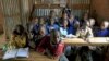 FILE - A class of children between the ages of six and seven years old pose for pictures in their classroom at Gifted Hands Educational Center in Kenya's Kibera neighborhood in the capital Nairobi, September 2015.