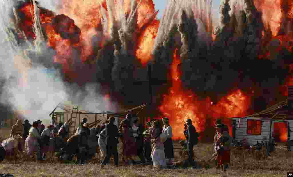 People perform during the reenactment of the battle of the beginning of WWII, in Lomianki near Warsaw, Poland.