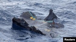 A floating object believed to belong to the U.S. military aircraft V-22 Osprey that crashed into the sea is seen off Yakushima Island