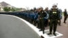 Cambodian riot police stand on a street awaiting the arrival of opposition supporters marching to the U.N. human rights office, in Phnom Penh, Cambodia, Wednesday, Oct. 23, 2013. Thousands of Cambodian opposition supporters began a three-day rally Wednesday to protest what they say was a rigged election and the illegitimate return to power of Prime Minister Hun Sen. (AP Photo)
