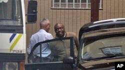 Nigerian ex-militant leader, Henry Okah (R) is led from the court in Johannesburg, 14 Oct 2010