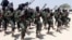 FILE - Hundreds of newly trained al-Shabab fighters perform military exercises in the Lafofe area, south of Mogadishu, Somalia.