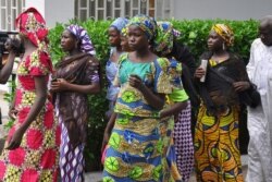 FILE - Schoolgirls, who escaped from Boko Haram kidnappers in the village of Chibok, arrive at the Government house to speak with State Governor Kashim Shettima, in Maiduguri, Nigeria, June 2, 2014.