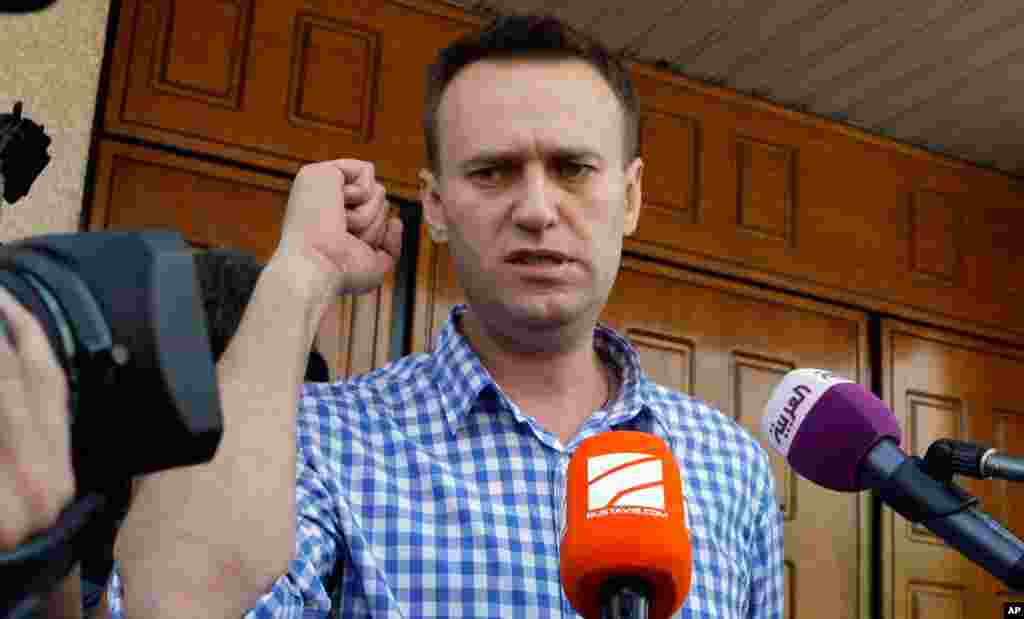 Russian opposition leader Alexei Navalny speaks to the media at the headquarters of the Russian Investigation committee in Moscow, June 12, 2012.