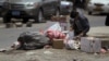 A boy searches for food amongst litter on a street in Sana'a, Yemen, April 8, 2015.