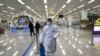 State Commission of Quality Management staff member in protective gear carries a disinfectant pray can as they continue to check the health of travelers and inspect and quarantine goods at the Pyongyang Airport in Pyongyang, North Korea, Feb. 1, 2020.