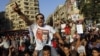 An Egyptian supporter of Muslim brotherhood candidate Mohammed Morsi wearing a shirt with Arabic that reads, "'Mohammed Morsi, president for Egypt" chants slogans in Tahrir Square, Cairo, Egypt, June 18, 2012.