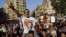 An Egyptian supporter of Muslim brotherhood candidate Mohammed Morsi wearing a shirt with Arabic that reads, "'Mohammed Morsi, president for Egypt" chants slogans in Tahrir Square, Cairo, Egypt, June 18, 2012.