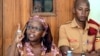 FILE - Makerere University researcher Dr. Stella Nyanzi, left, gestures in the dock at Buganda Road Court in Kampala, Apr. 10, 2017.