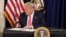U.S. President Donald Trump signs executive measures for economic relief during a news conference amid the spread of the coronavirus disease, at his golf resort in Bedminster, N.J., Aug. 8, 2020. 