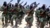 FILE - Al-Shabab fighters are seen marching with their weapons during exercises on the outskirts of Mogadishu, Somalia, Feb. 17, 2011. 