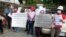 Former beer promoters on August 5, 2015 staged a strike in front of Anco Brother Co., Ltd by showing banners demanding that the company compensate them for their dismissal which allegedly was illegally by Cambodia's Labor Law. (Courtesy of Cambodian Food and Service Federation)