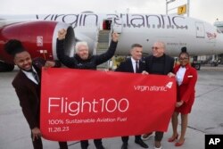 Virgin Atlantic Founder, Sir Richard Branson, UK Transport Secretary Mark Harper, and CEO, Shai Weiss, celebrate arrival of Flight100 in NYC, Tuesday, Nov. 28, 2023 in New York. (Jason DeCrow/AP Images for Virgin Atlantic Airways Ltd)
