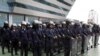 Thai riot policemen stand guard outside the Constitution Court during a ruling Friday, July 13, 2012 in Bangkok, Thailand.